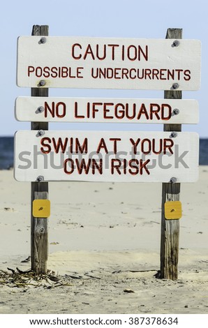 Warning signs on a sandy beach on a barrier island