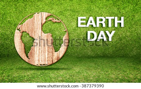Earth day word with wood world globe icon at green grass room,Ecology concept, Leave space for adding your text