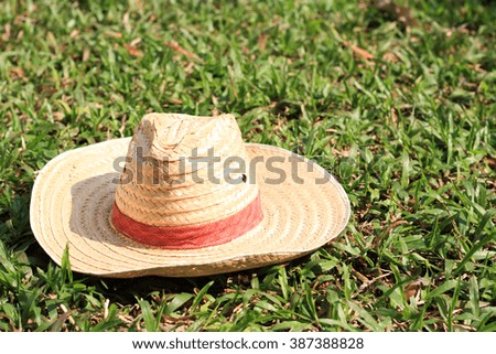 Brown woven hat on the grass.
