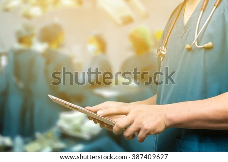 Male doctor,medical students or surgeon using  tablet and laptop during the conference,Health Check with digital system support for patient,test results and information registration,selective focus