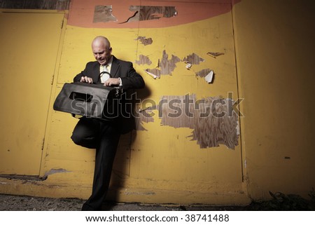 Man going through his briefcase at night