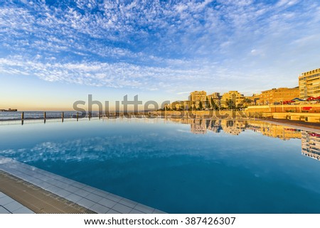 Seapoint swimming pool with sunset reflection Royalty-Free Stock Photo #387426307