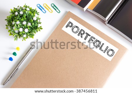 Text Portfolio on brown paper book on table / business concept Royalty-Free Stock Photo #387456811