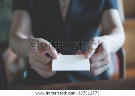 business girl or women showing an empty business card with two hand, closeup shot vintage color tone style /  contact me
