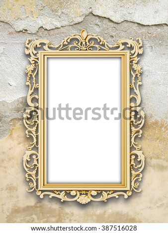Close-up of one golden Baroque frame on cracked and scratched wall background