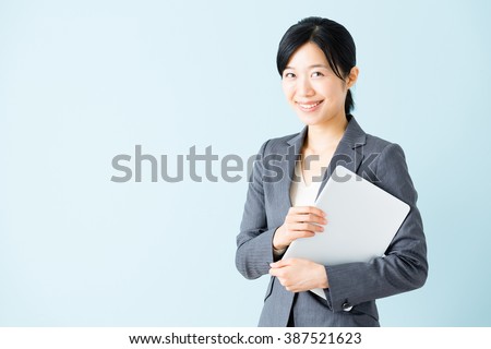 portrait of  asian businesswoman isolated on blue background