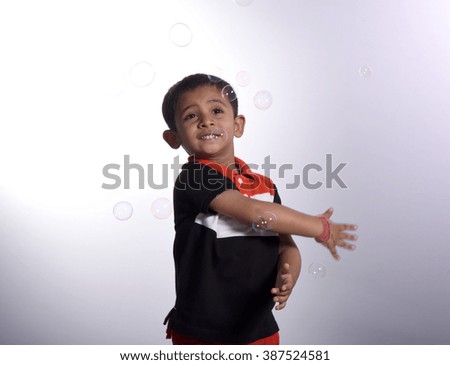 Portrait of boy in action with bubble