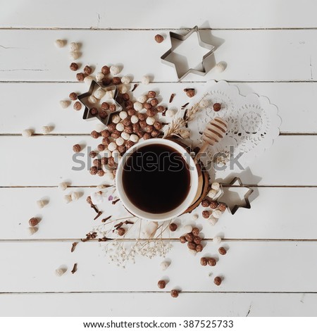 Cup of black coffee and corn balls at white background. Flat lay