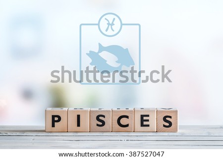 Pisces star sign on a wooden table