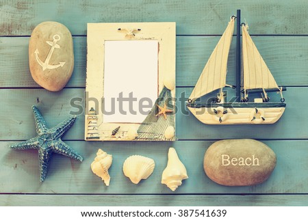 wooden nautical frame and sailing boat on wooden table. nautical lifestyle concept. vintage filtered. template, ready to put photography