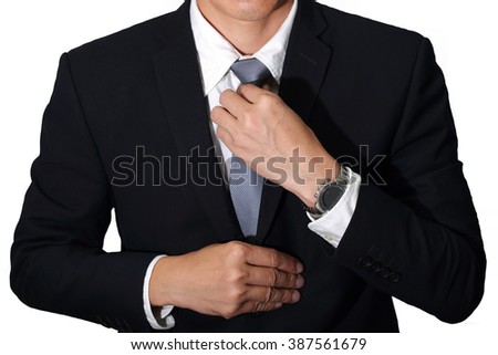 Businessman held necktie dress to look good on white background as business concept.