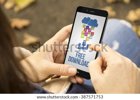 connectivity concept: woman holding a 3d generated smartphone with free download on the screen. Graphics on screen are made up.