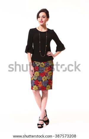 indian asian eastern brunette business executive woman with straight hair style in printed summer skirt and black blouse high heel shoes standing full body length isolated on white
