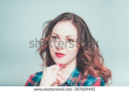 Portrait of a young woman has a good idea isolated on a gray background