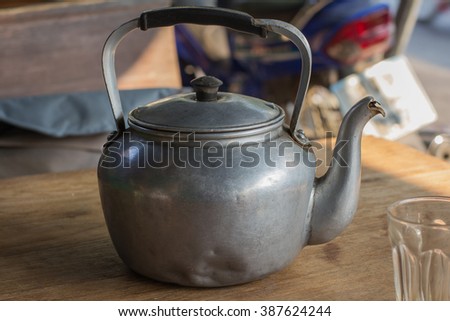 Thai hot tea, soft-boiled eggs and kettle, antiques thai style in countryside coffee shop.