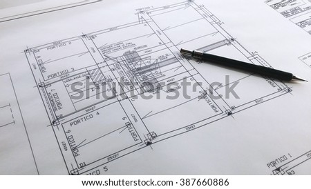 Architectural drawings and pencil on a table