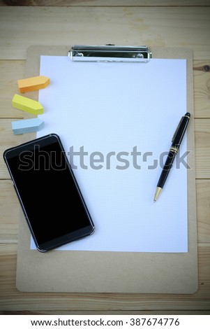 smartphone ,  note book on wood desk , business concept ,business strategy , analysis concept