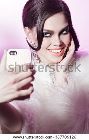 pretty girl doing selfie on the pink background