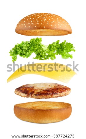 American food. Burger layers isolated. Separated burger layers isolated. Hamburger explosion. Cheeseburger flying fillings isolated at white background. Levitation of burger and cheese, meat, lettuce. Royalty-Free Stock Photo #387724273