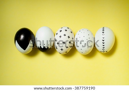 minimal trendy graphic modern monochome easter eggs on solid yellow background. easter postcard invitation