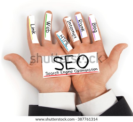 Photo of hands holding paper cards with SEO concept words