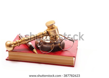 Gavel, glasses, pen and red book on a white background
