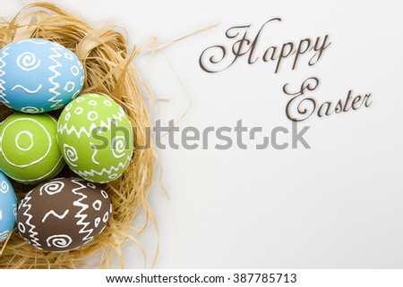 Easter card. Painted Easter eggs in nest isolated on white gray background