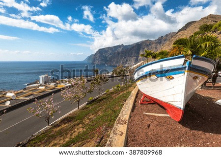 Colourful painted fishing boat near the ocean in Los Gigantes, Tenerife, Canary Islands, a picture postcard scenic view of the island.