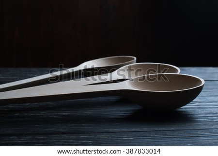Wood spoons on wooden table background. Kitchen utensils. wood spoons on dark brown background. Big spoons