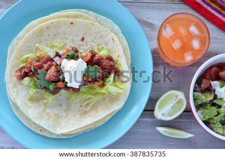 Flat lay of Mexican food Tortilla served with Margarita and Guacamole dip. Food background and texture