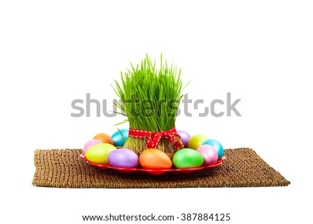 Colored eggs, wheat springs on Nowruz holiday on white background. Selective focus.