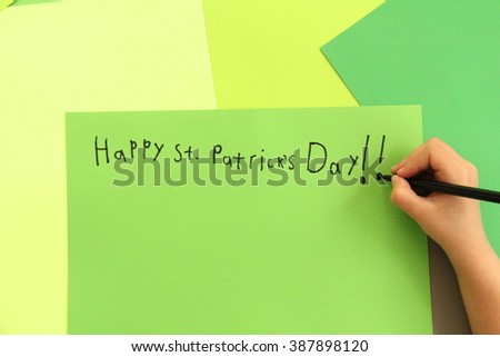 Happy St. Patrick's Day! Child's hand drawing with pen on green paper