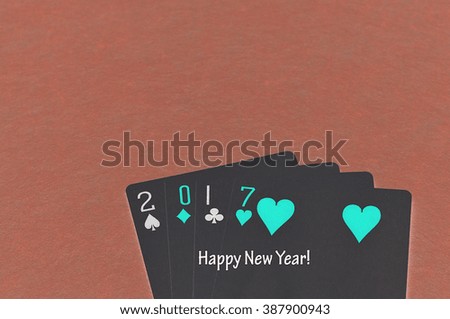 2017 made out of playing cards with the words happy new year written on it with an invert effect on the photo 
