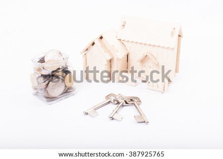 model of house with keys,coins money and white background