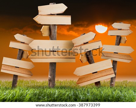 Many Wooden sign on the lawn with sunset