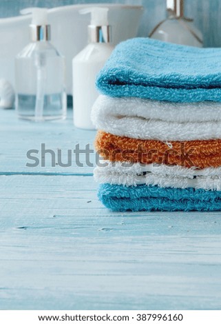 stack of colorful towels on the table, accessories for the bathroom