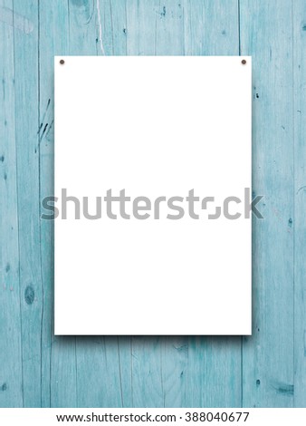 Close-up of one paper sheet frame with nails on aqua wooden background