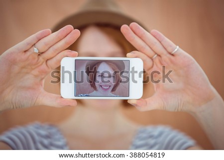 smiling hipster woman taking a selfie