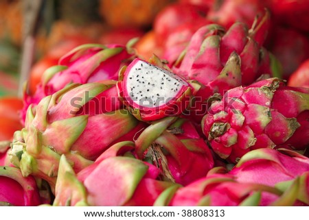 fresh raw dragon fruit heap on open market