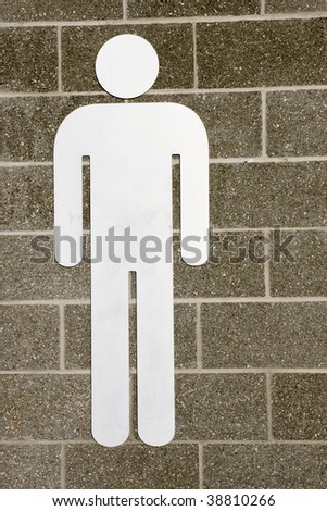 A male washroom sign on a brick wall