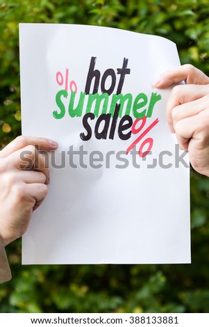 hands holding paper with sentence, hot summer sale