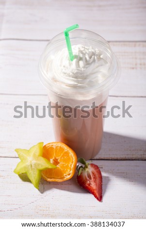 tasty, frappucino with whipped cream, on wooden background
