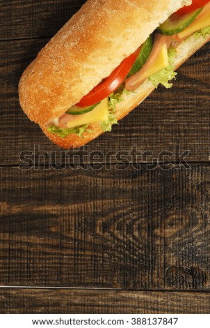 big toasted sandwich on a dark wooden table
