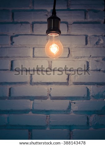 Vintage lamp near old cracked bricks wall