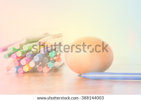 Easter Egg Chickens and color pen on wooden table