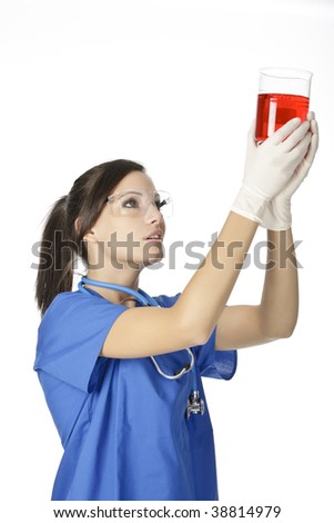 Beautiful Caucasian woman working as a laboratory technician studing a beaker of red liquid isolated on a white background