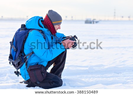 photographer in blue jacket outdoors