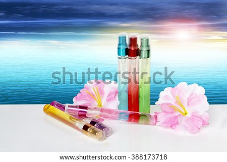 perfume bottle and flower with flare light and ocean background