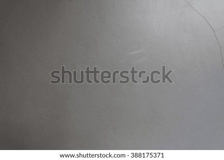 Gray cement wall of damaged with light and shadow for the background design.