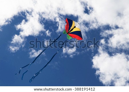 Kite in blue sky with clouds